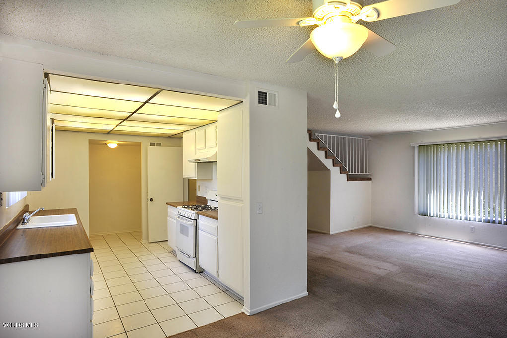 5711 Cochran Street Simi Valley, CA 93063 - Photo 5 of 25 a view of a hallway with bedroom and chandelier