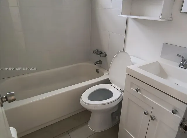 a bathroom with a sink a toilet and bathtub