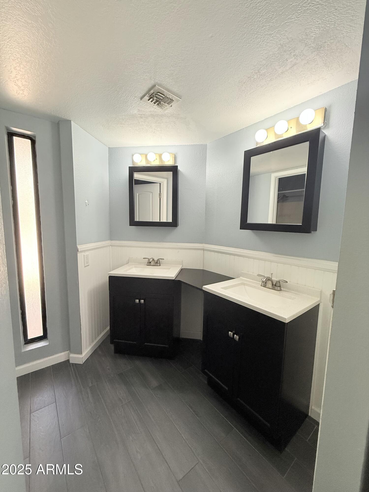 11666 North 28th Drive, Unit 155 Phoenix, AZ 85029 - Photo 12 of 28 a bathroom with a sink and a mirror