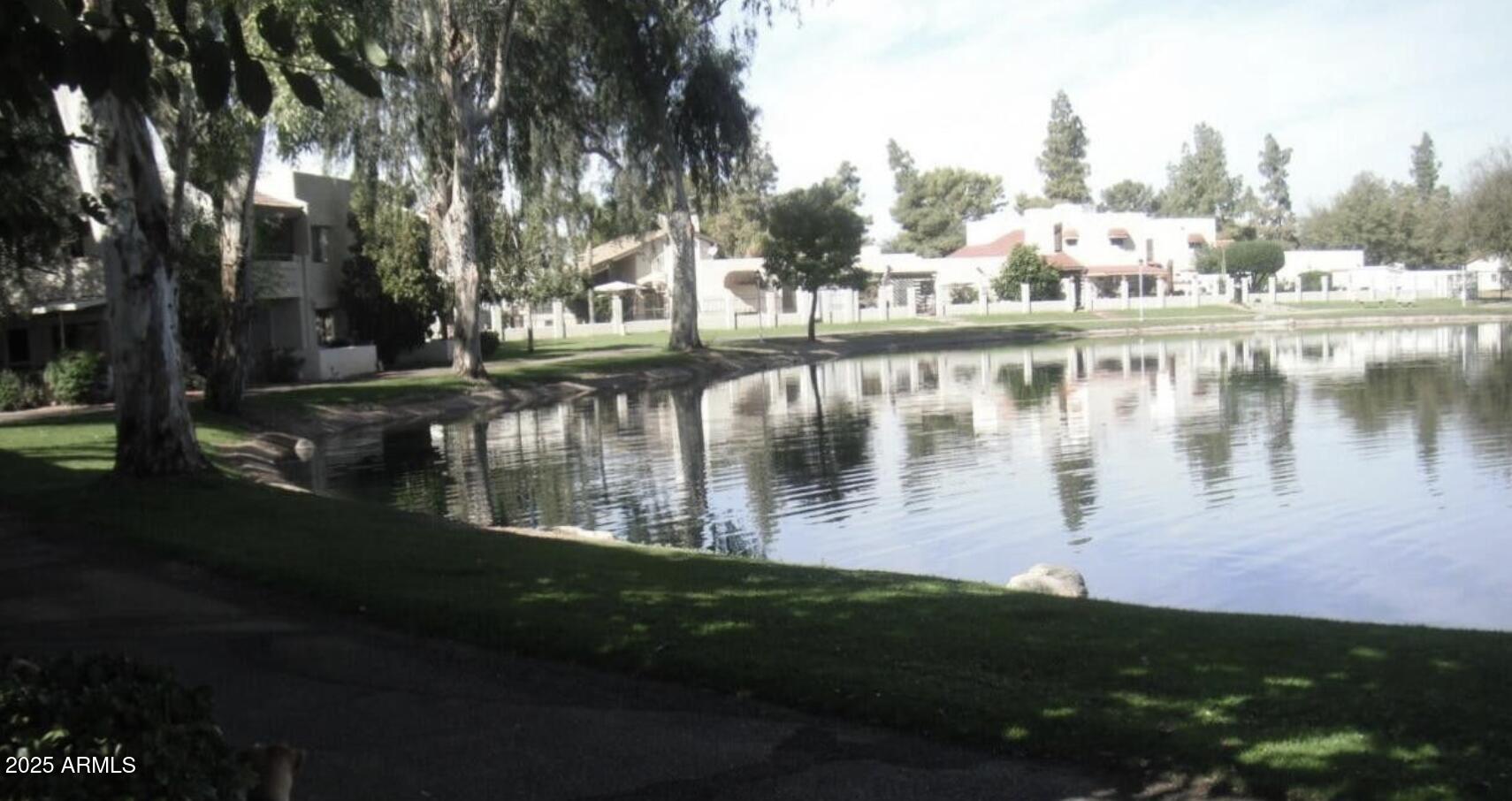 11666 North 28th Drive, Unit 155 Phoenix, AZ 85029 - Photo 27 of 28 a view of a lake with a yard and large trees