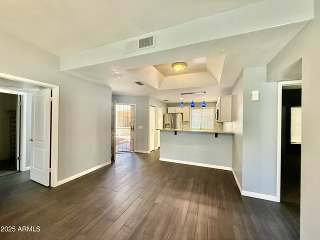 a view of empty room with wooden floor