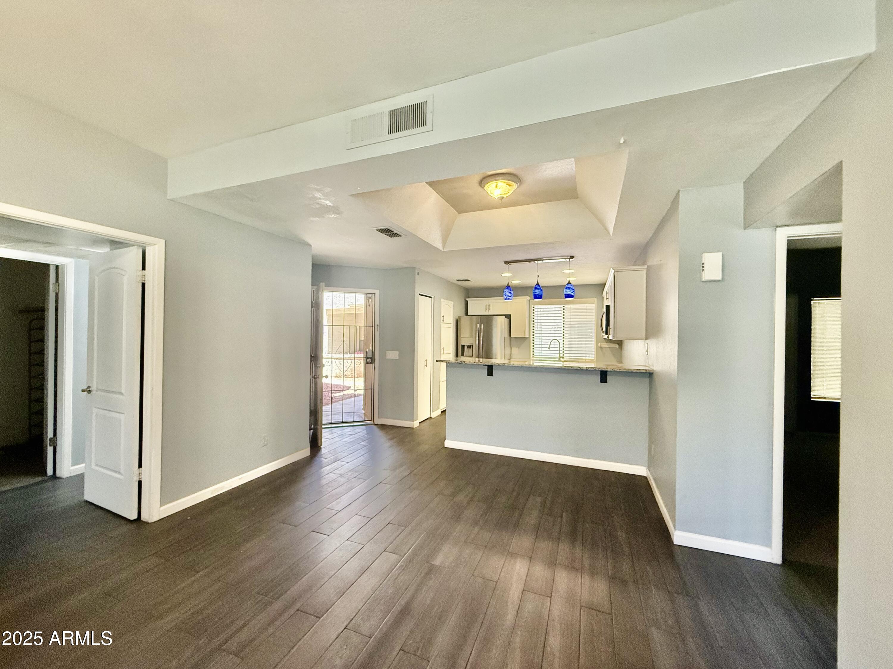 11666 North 28th Drive, Unit 155 Phoenix, AZ 85029 - Photo 3 of 28 a view of empty room with wooden floor