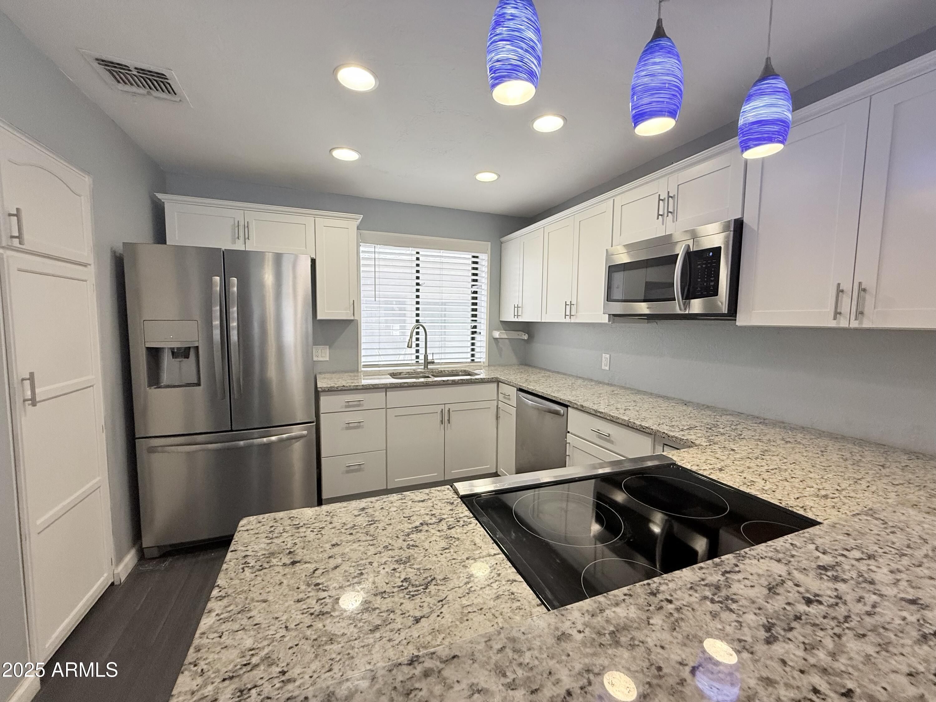 11666 North 28th Drive, Unit 155 Phoenix, AZ 85029 - Photo 4 of 28 a kitchen with a refrigerator sink and microwave