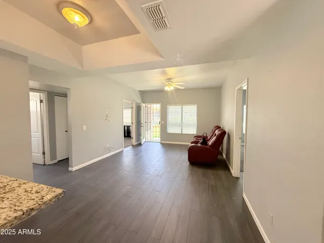 a hallway with a couch and chandelier