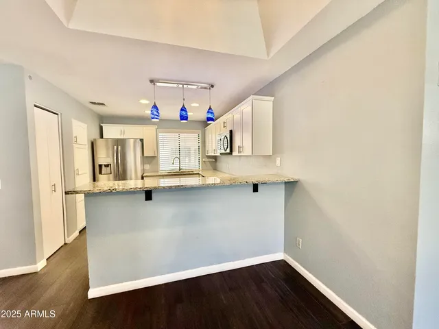 a view of cabinets and wooden floor