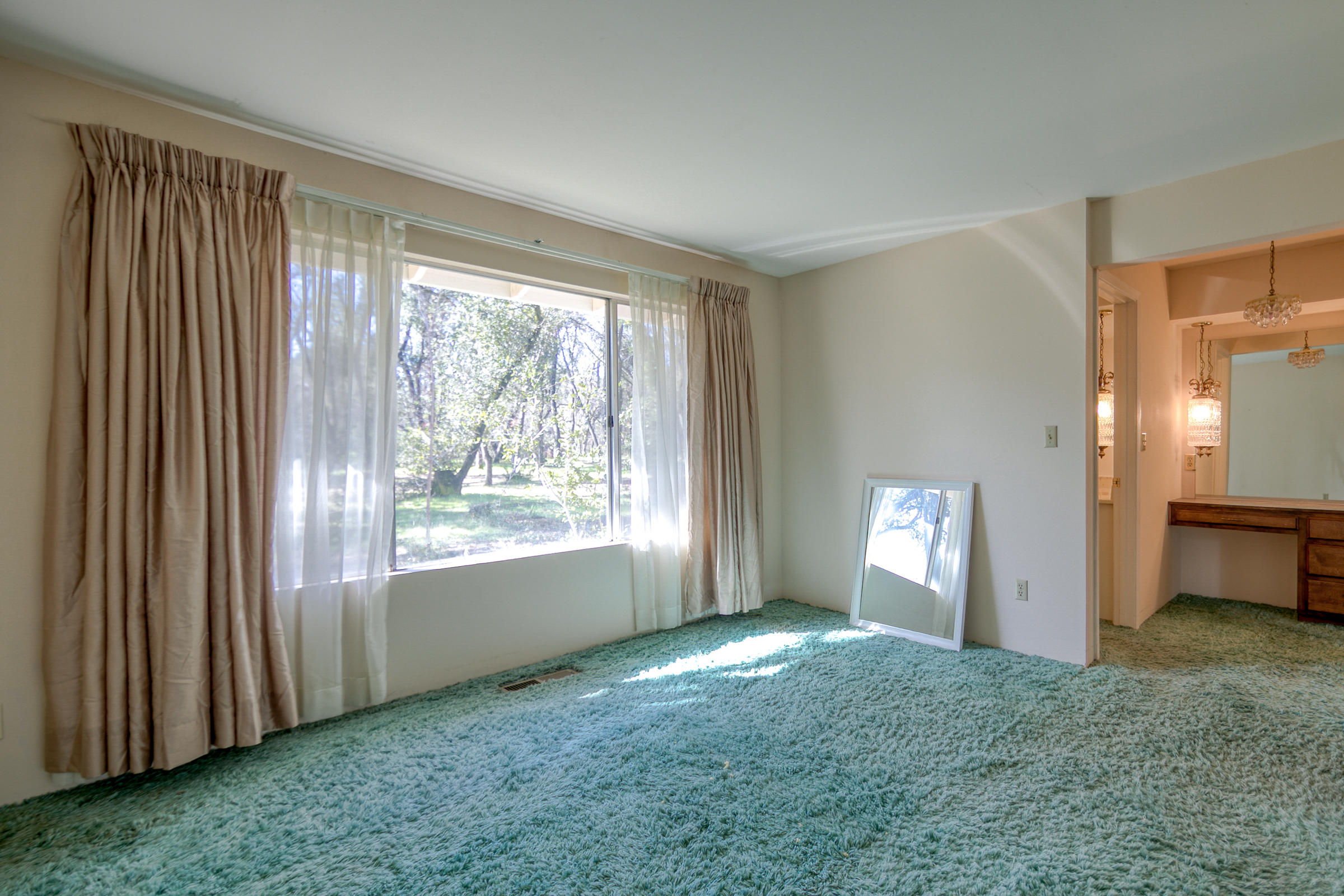 8442 Ranchette Drive Redding, CA 96001 - Photo 20 of 26 a view of an empty room and window and a kitchen