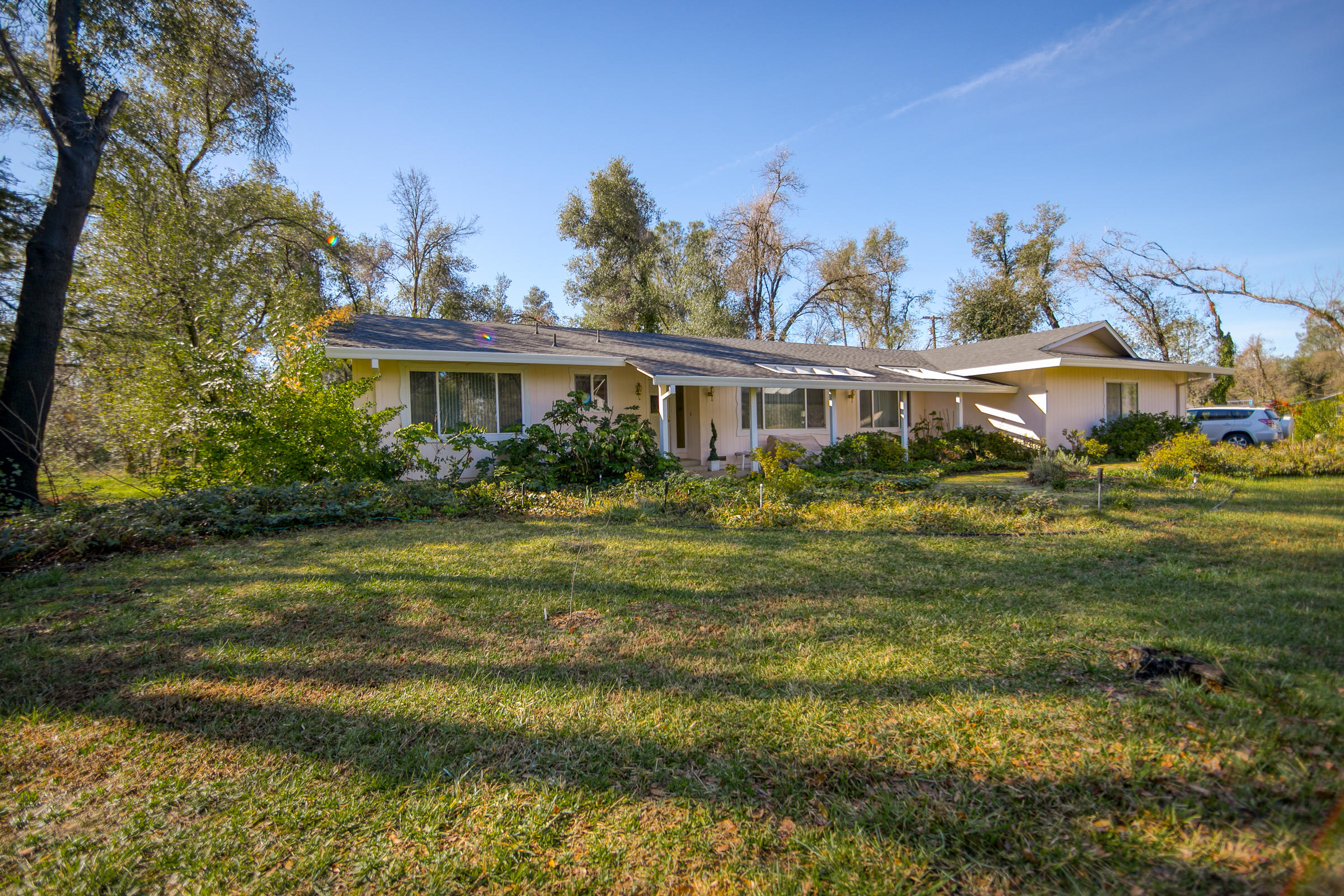 8442 Ranchette Drive Redding, CA 96001 - Photo 2 of 26 a front view of residential houses with yard and green space