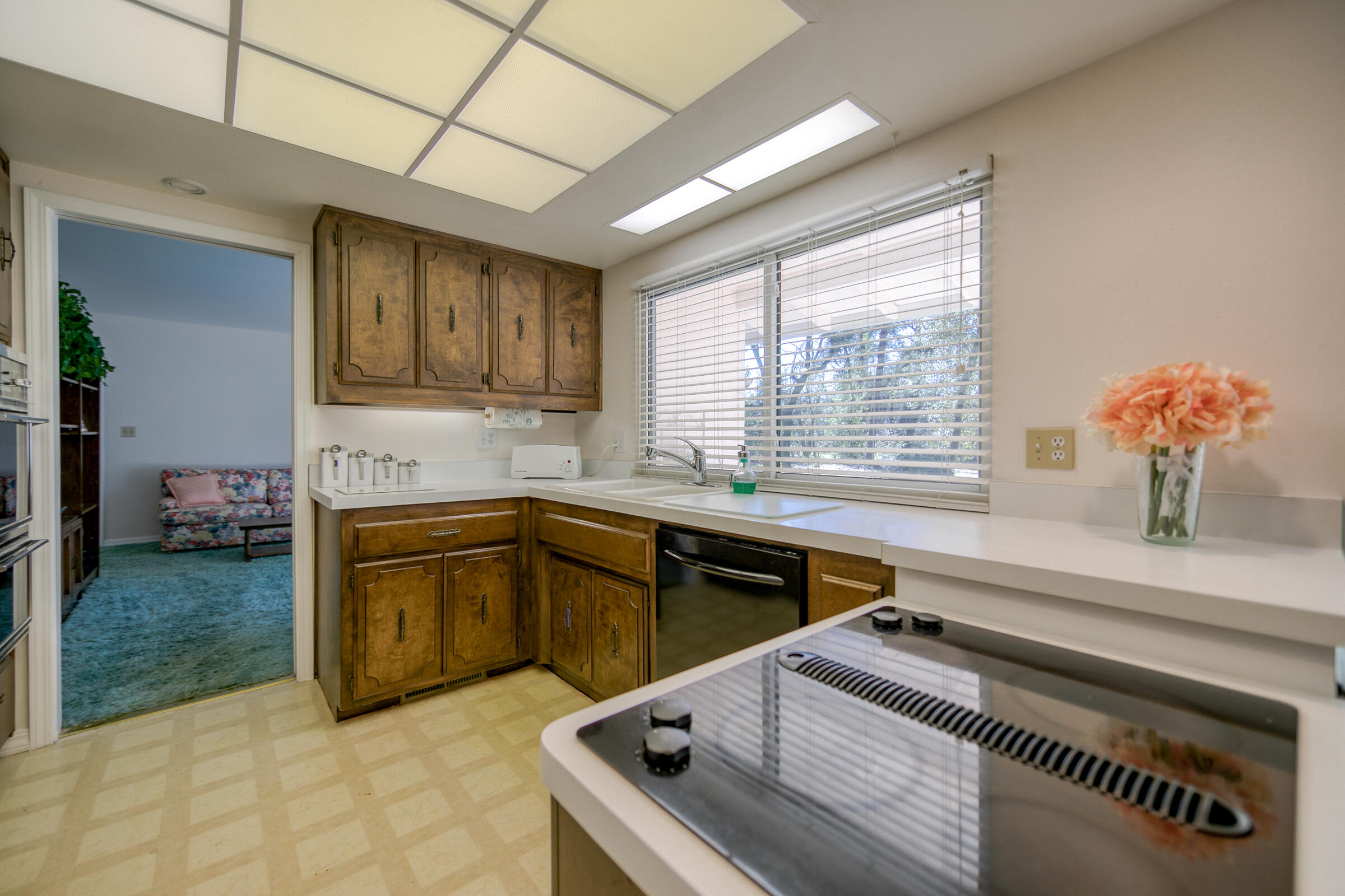 8442 Ranchette Drive Redding, CA 96001 - Photo 24 of 26 a kitchen with a stove sink and cabinets