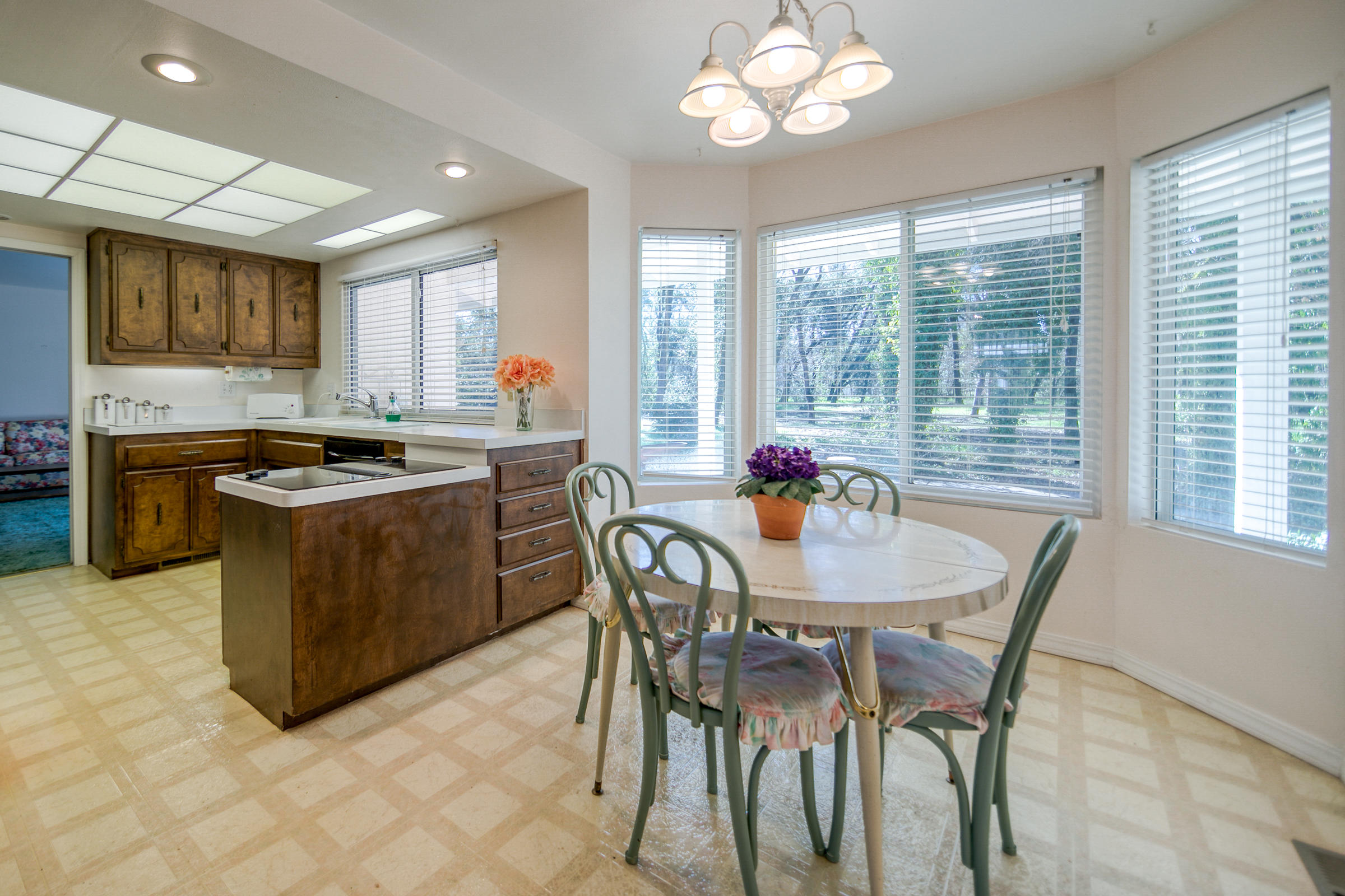 8442 Ranchette Drive Redding, CA 96001 - Photo 26 of 26 a kitchen with a stove a sink a kitchen island with chairs and wooden floor