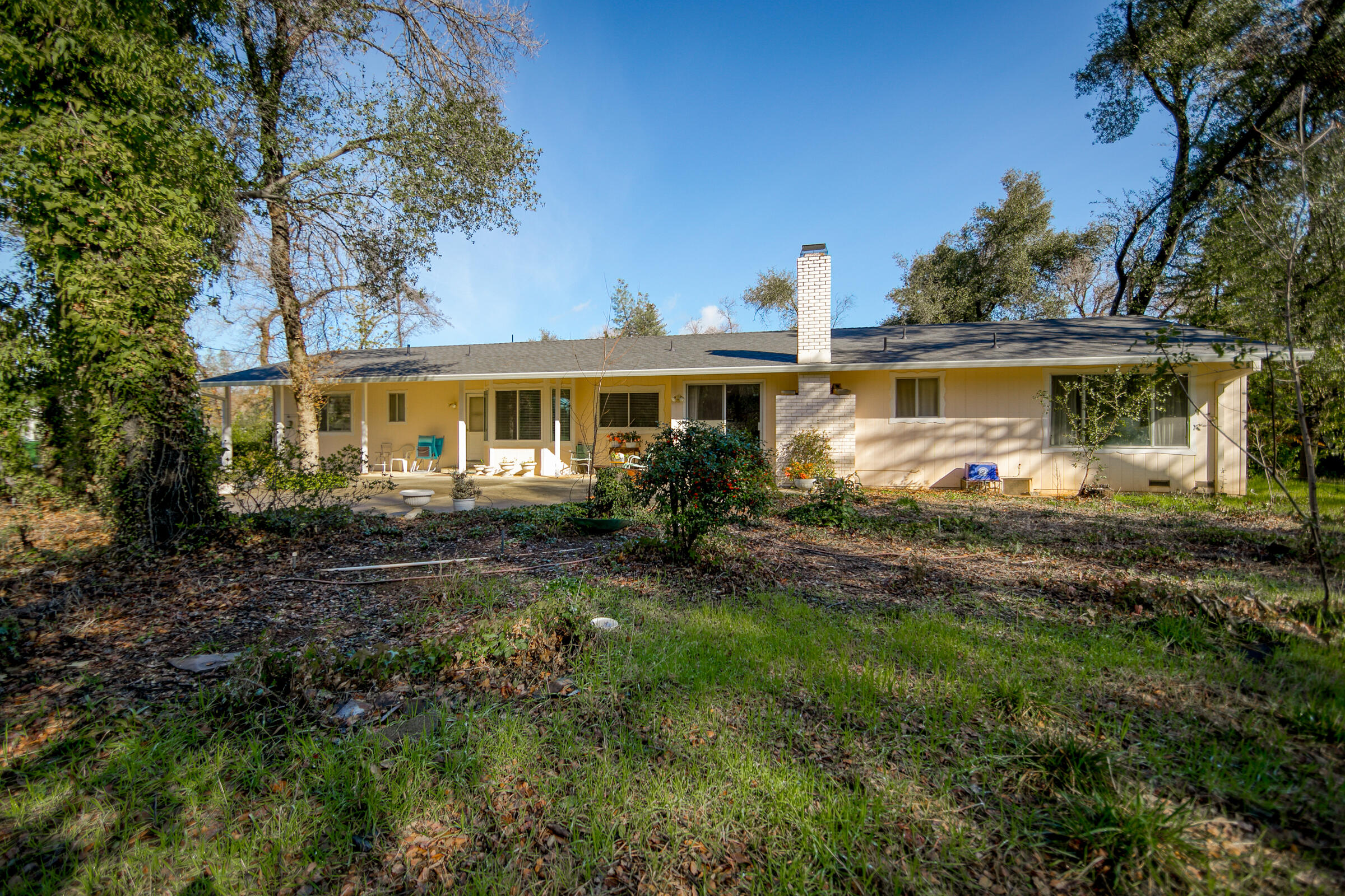 8442 Ranchette Drive Redding, CA 96001 - Photo 5 of 26 a view of a house with a yard