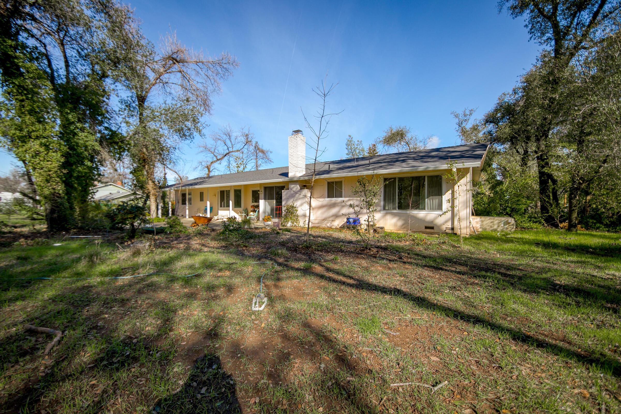8442 Ranchette Drive Redding, CA 96001 - Photo 6 of 26 a front view of a house with a yard