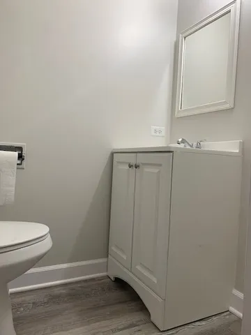 a bathroom with a toilet and a mirror