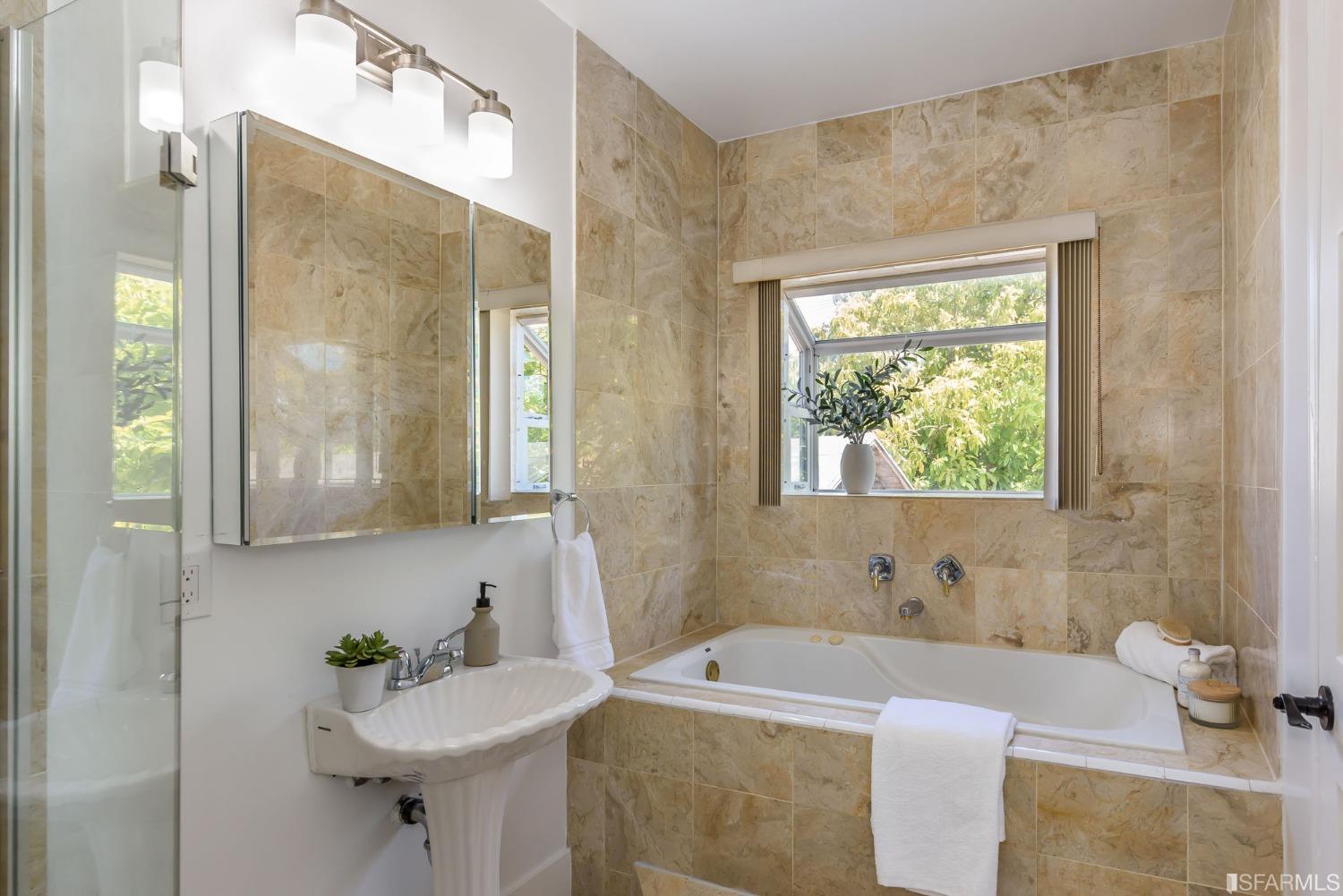 9 Bancroft Road Burlingame, CA 94010 - Photo 21 of 45 a bathroom with a tub sink and mirror