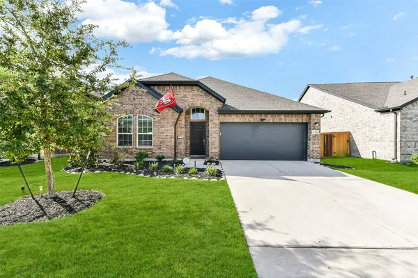 a front view of a house with a yard and garage