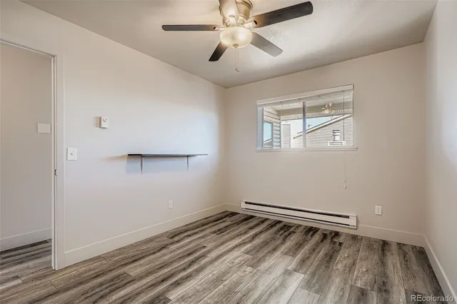 a view of room with hardwood floor and ceiling fan