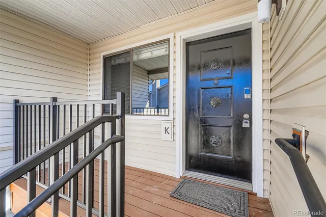 a view of a porch with wooden floor and stairs