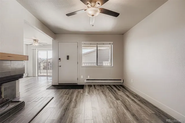 a view of livingroom with hardwood floor and a ceiling fan