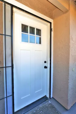 a kitchen with stainless steel appliances granite countertop a refrigerator a stove top oven a sink and dishwasher with wooden floor