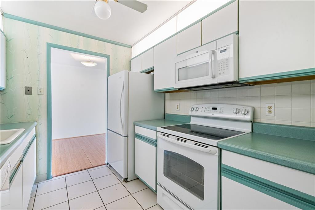 5600 Munhall Road, Unit 606 Pittsburgh, PA 15217 - Photo 13 of 30 a kitchen with white cabinets and white appliances