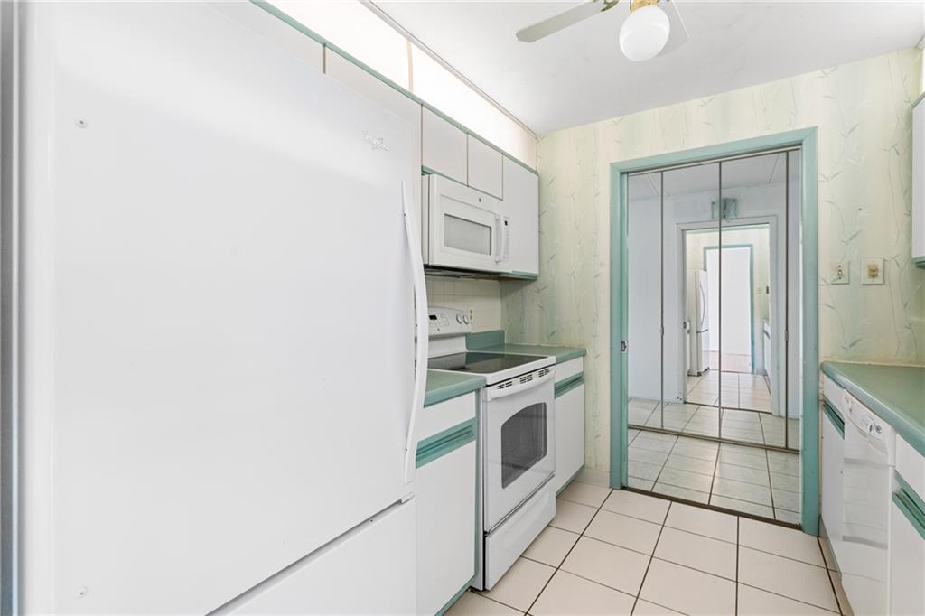 5600 Munhall Road, Unit 606 Pittsburgh, PA 15217 - Photo 15 of 30 a kitchen with granite countertop white cabinets and white appliances