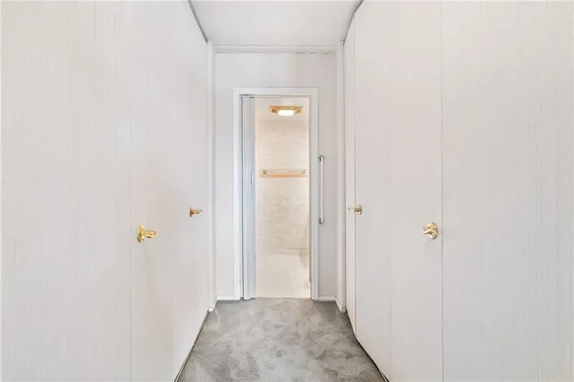 a view of a room with a wooden door