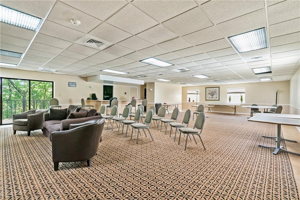 5600 Munhall Road, Unit 606 Pittsburgh, PA 15217 - Photo 24 of 30 a living room with furniture a rug kitchen view and a large window