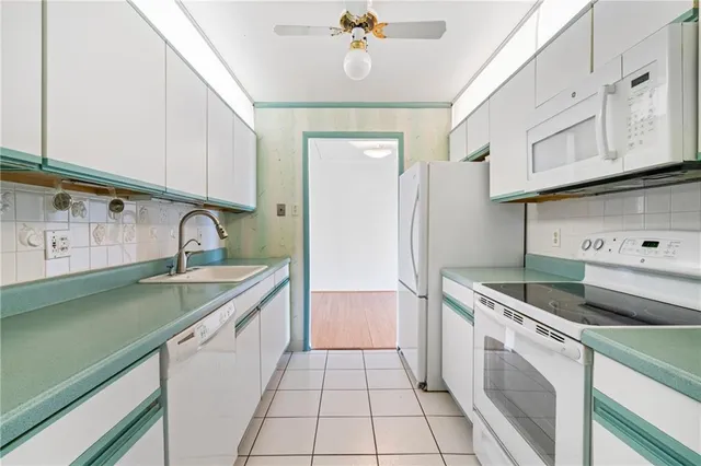 a kitchen with granite countertop a sink stainless steel appliances and cabinets