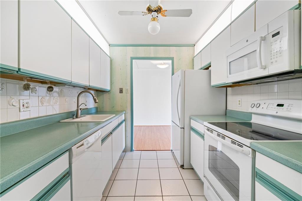 5600 Munhall Road, Unit 606 Pittsburgh, PA 15217 - Photo 4 of 30 a kitchen with granite countertop a sink stainless steel appliances and cabinets