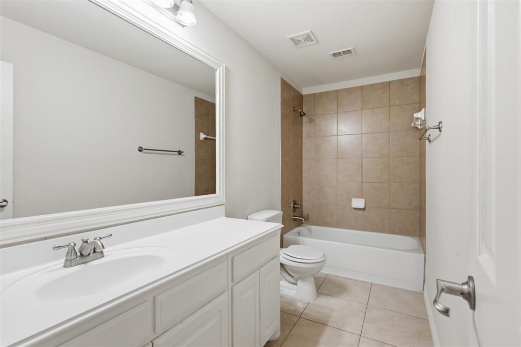 2841 Meadow Ridge Drive Prosper, TX 75078 - Photo 28 of 40 a bathroom with a sink a toilet and shower