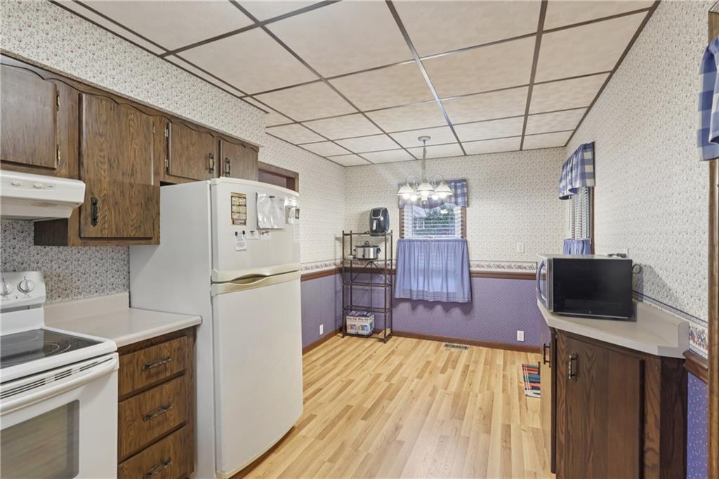 178 North Washington Road Apollo, PA 15613 - Photo 9 of 29 a kitchen with a refrigerator a stove and wooden cabinets