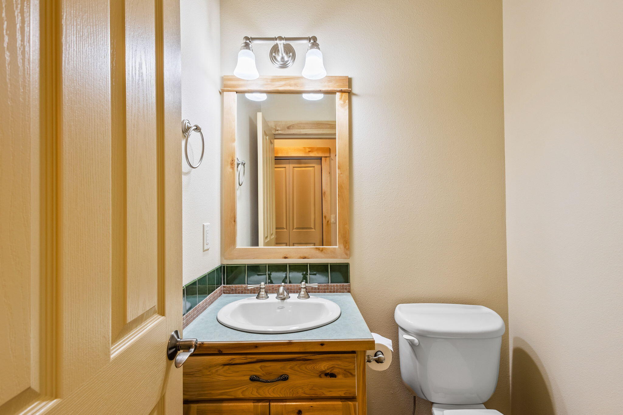 21405 Back Alley Road Bend, OR 97702 - Photo 19 of 48 a bathroom with a toilet sink and mirror