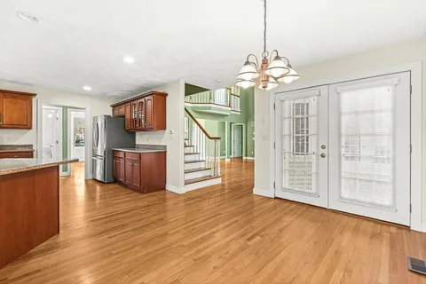 a view of a room with wooden floor and windows