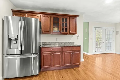 a kitchen with stainless steel appliances granite countertop a refrigerator and a stove top oven