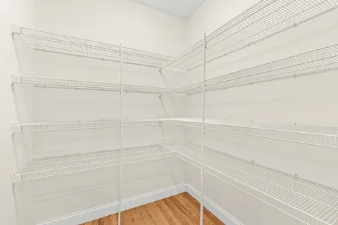 a view of a closet and wooden floor