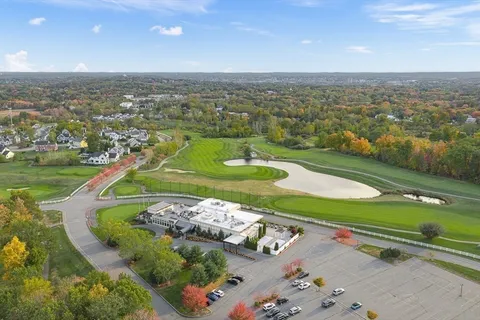 an aerial view of a houses with a yard