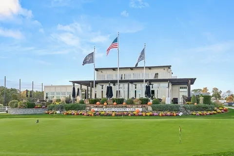 a front view of multiple houses with yard