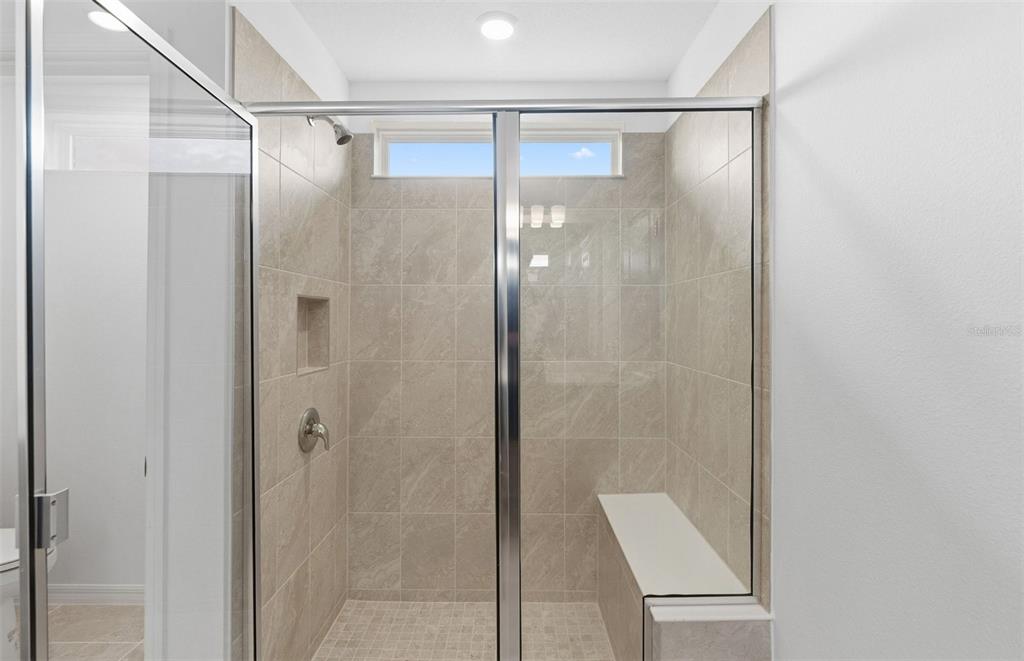 1277 Lakeridge Way Lake Lake Alfred, FL 33850 - Photo 11 of 29 a bathroom with a glass shower door