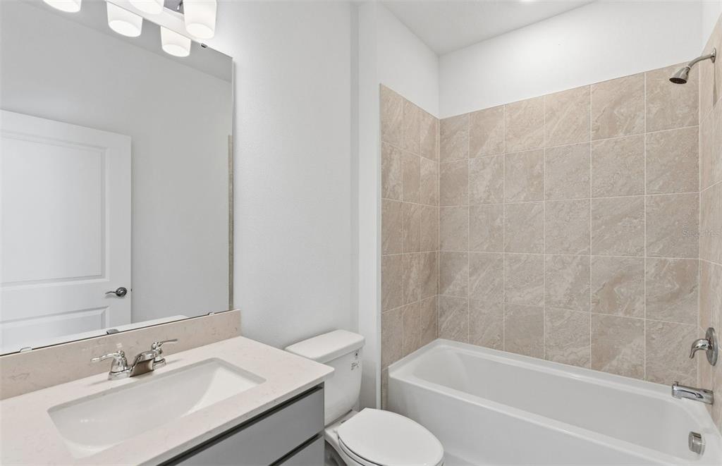 1277 Lakeridge Way Lake Lake Alfred, FL 33850 - Photo 7 of 29 a bathroom with a sink toilet and bathtub