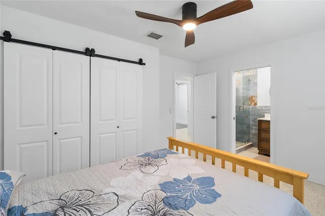 a bedroom with a bed and a chandelier