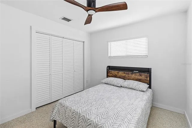 a bedroom with a bed and a window