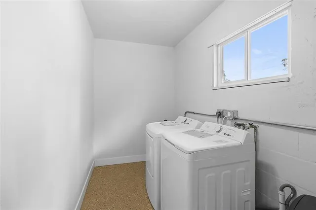 a utility room with a sink a mirror and vanity