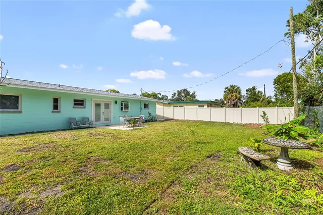 a view of an house with backyard space and garden