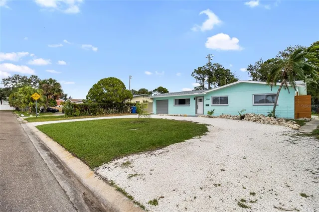 a front view of a house with a garden and yard