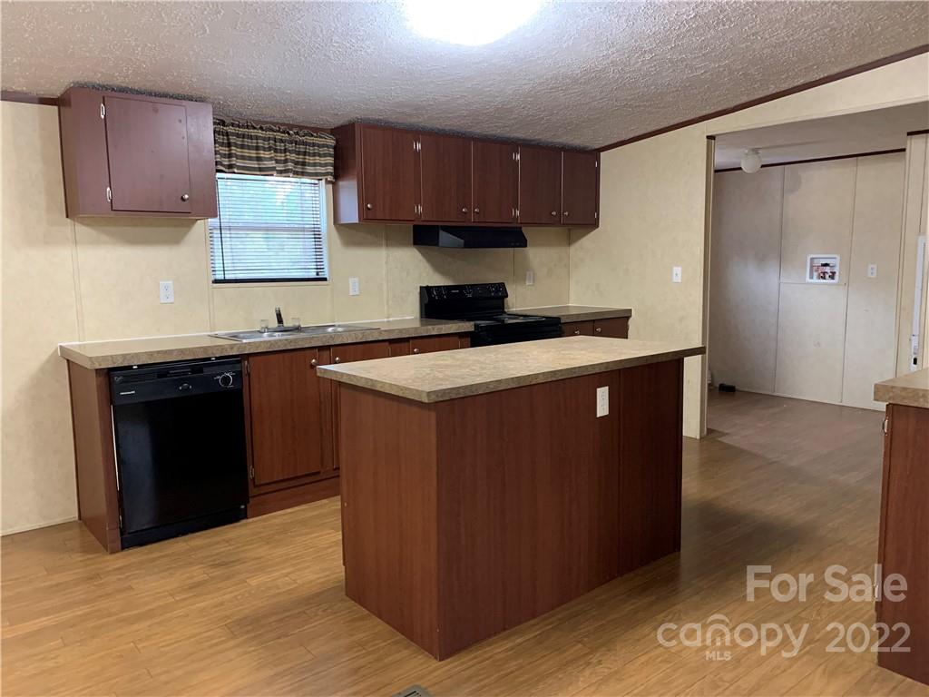 175 Mosley Road Blacksburg, SC 29702 - Photo 11 of 23 a kitchen with stainless steel appliances granite countertop a stove a sink and a refrigerator