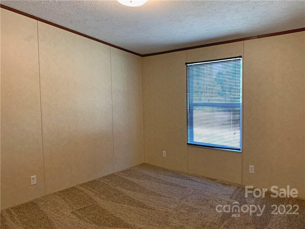 175 Mosley Road Blacksburg, SC 29702 - Photo 23 of 23 a view of an empty room with wooden floor and a window