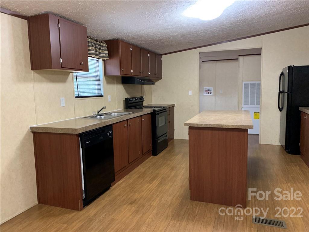 175 Mosley Road Blacksburg, SC 29702 - Photo 8 of 23 a kitchen with stainless steel appliances granite countertop a sink stove and refrigerator