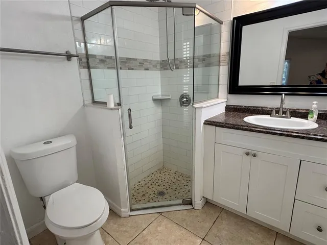 a bathroom with a toilet sink and shower