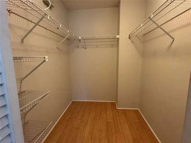 a view of a room with wooden floor and white walls