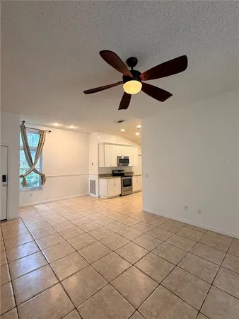 a kitchen with stainless steel appliances granite countertop a sink stove refrigerator and cabinets