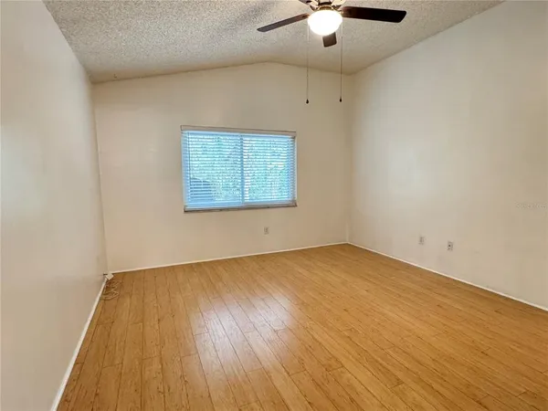 a view of a room with wooden floor and white walls